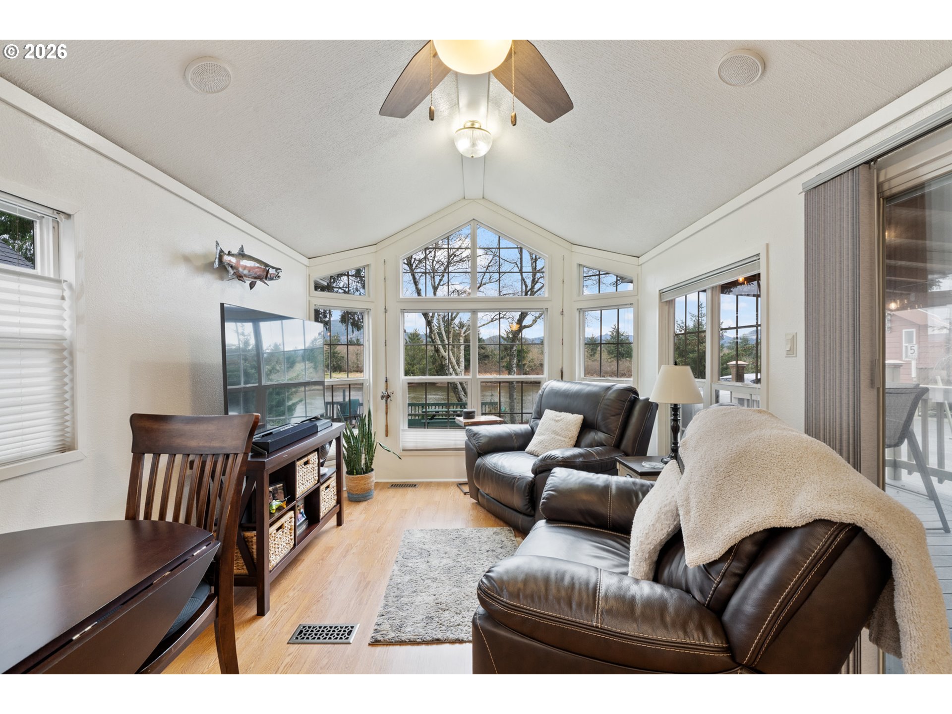 37395 North Fork Road, Unit 13 Nehalem, OR 97131 - Photo 10 of 34 a living room with furniture a chandelier and a large window