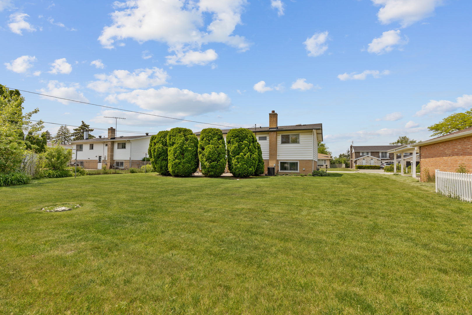 9363 Clancy Drive Des Plaines, IL 60016 - Photo 20 of 27 a front view of a house with a garden