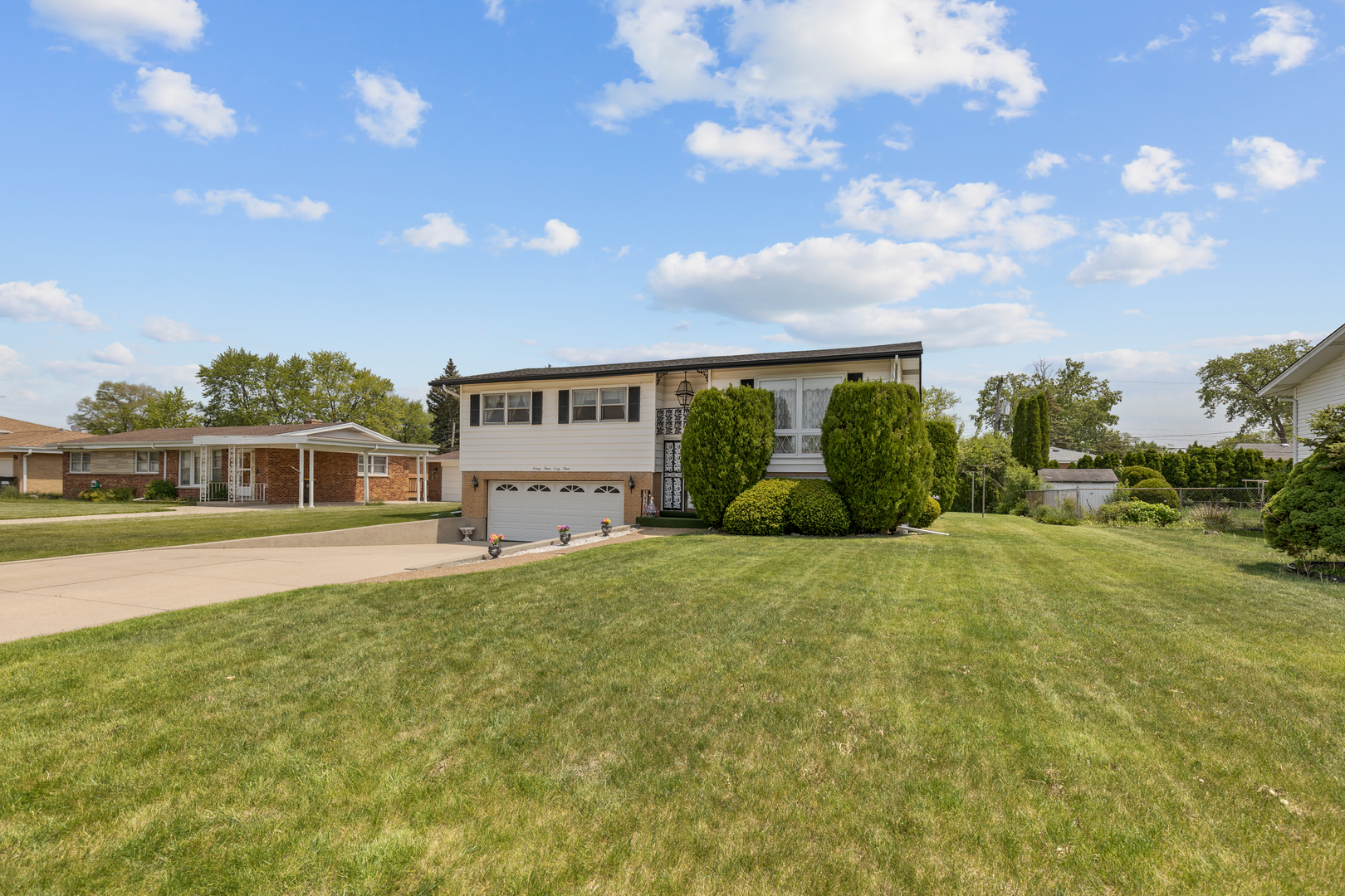 9363 Clancy Drive Des Plaines, IL 60016 - Photo 25 of 27 a front view of a house with a garden