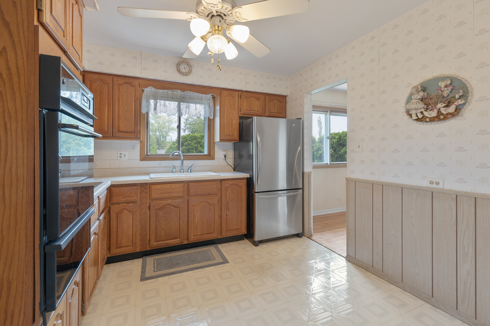 9363 Clancy Drive Des Plaines, IL 60016 - Photo 8 of 27 a kitchen with refrigerator cabinets and a large window
