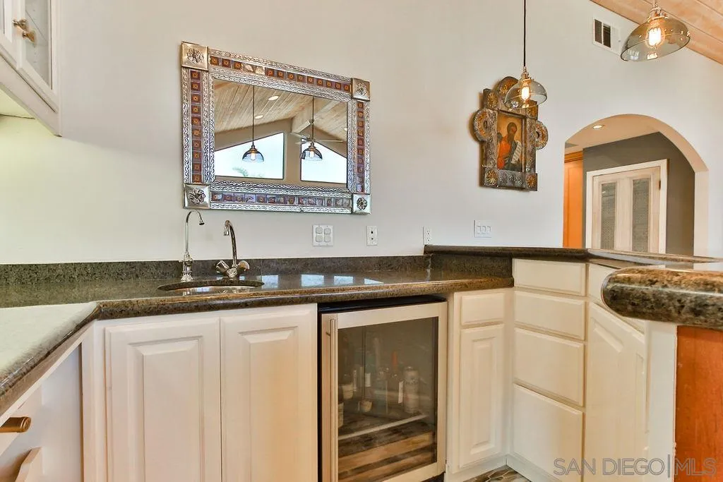 17695 Valle Verde Road Poway, CA 92064 - Photo 18 of 63 a bathroom with a granite countertop sink a mirror and a vanity