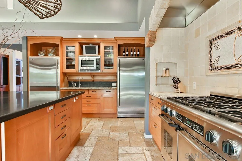 17695 Valle Verde Road Poway, CA 92064 - Photo 20 of 63 a kitchen with stainless steel appliances granite countertop a stove and a refrigerator