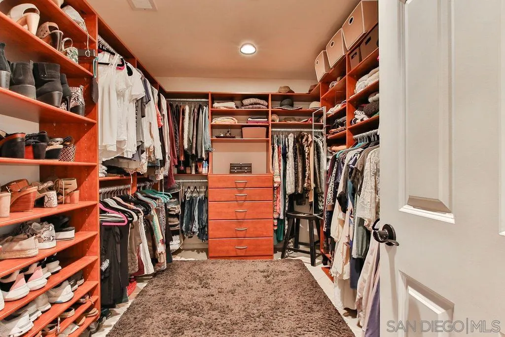 17695 Valle Verde Road Poway, CA 92064 - Photo 26 of 63 a view of walk in closet with clothes and shoes