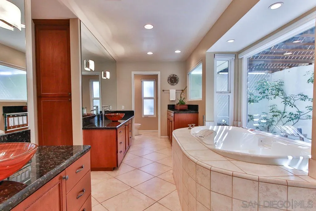 17695 Valle Verde Road Poway, CA 92064 - Photo 29 of 63 a large kitchen with kitchen island granite countertop a large counter top and stainless steel appliances