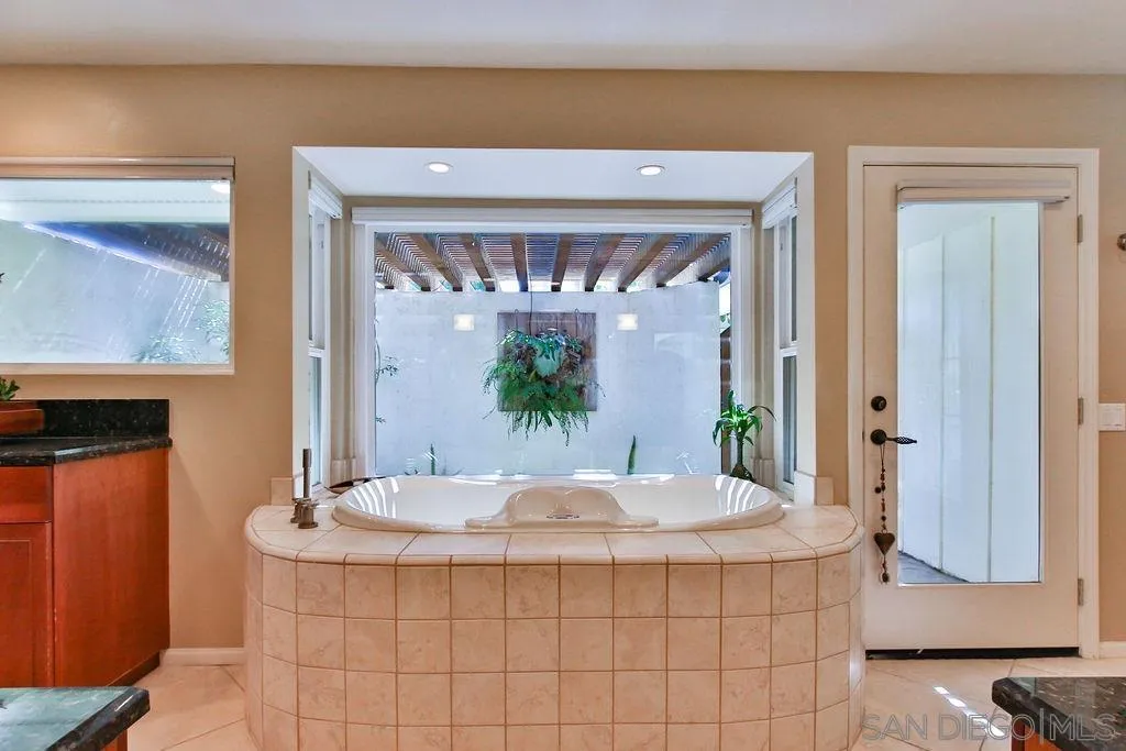 17695 Valle Verde Road Poway, CA 92064 - Photo 30 of 63 a view of a bathroom with a sink and a mirror