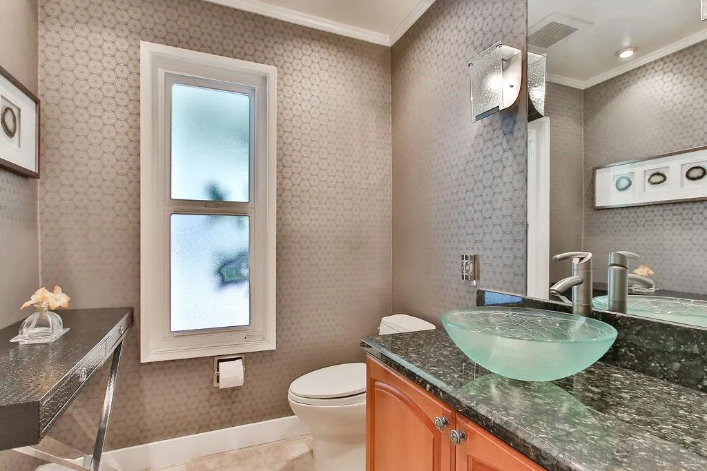 17695 Valle Verde Road Poway, CA 92064 - Photo 33 of 63 a bathroom with a granite countertop sink a toilet a mirror and shower curtain