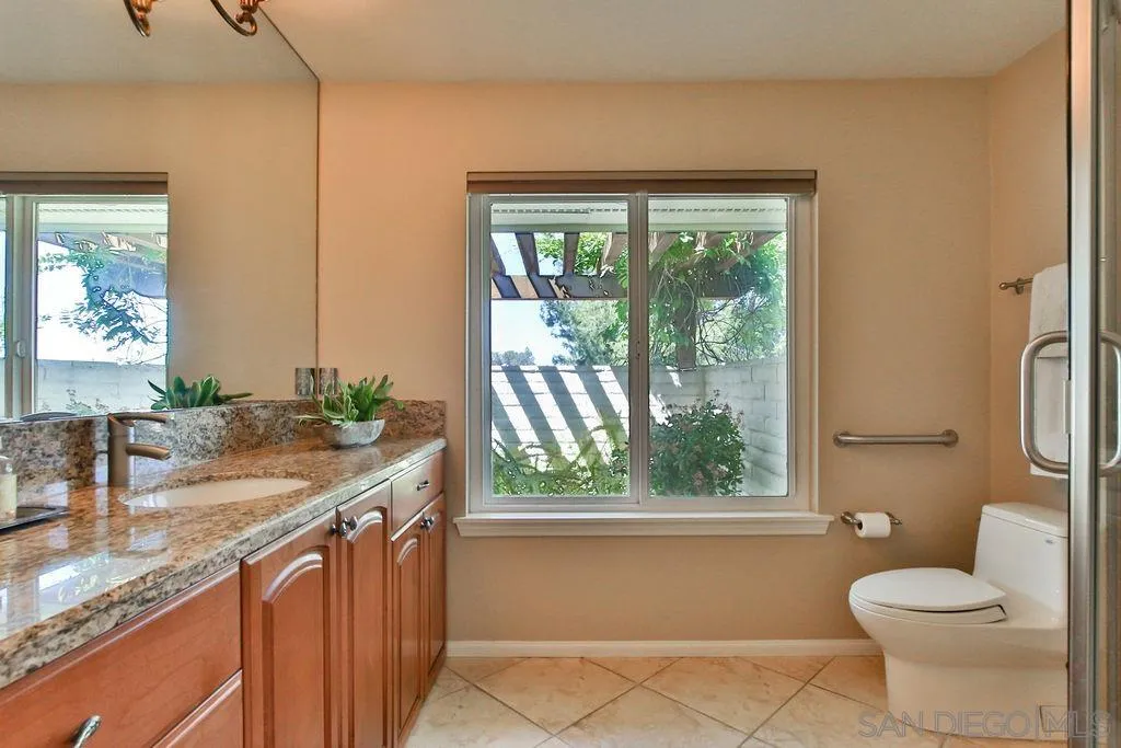 17695 Valle Verde Road Poway, CA 92064 - Photo 35 of 63 a bathroom with a granite countertop sink a large mirror and a window