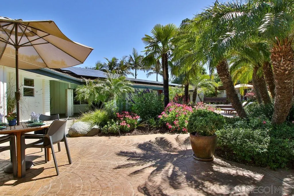 17695 Valle Verde Road Poway, CA 92064 - Photo 37 of 63 a view of a patio with table and chairs under an umbrella