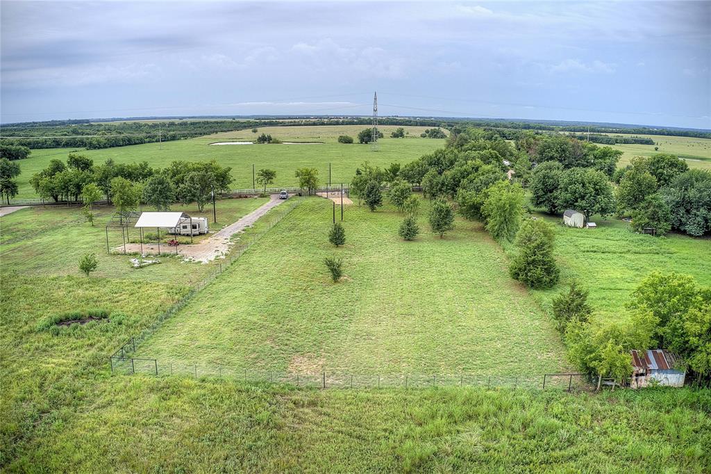 868 County Road 23940 Brookston, TX 75421 - Photo 22 of 29 a view of a swimming pool and a yard