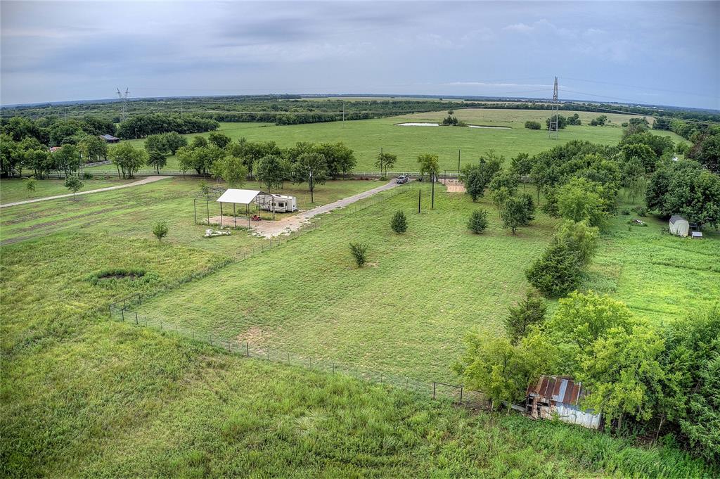 868 County Road 23940 Brookston, TX 75421 - Photo 25 of 29 a backyard of a building with a yard and outdoor seating