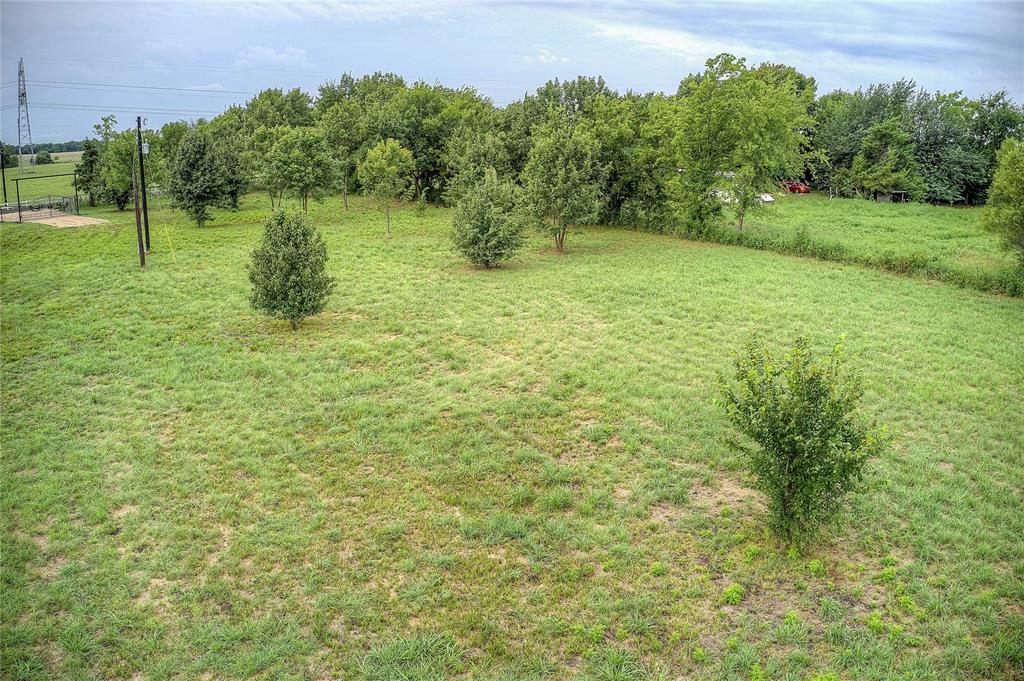 868 County Road 23940 Brookston, TX 75421 - Photo 27 of 29 a backyard of a house with lots of green space