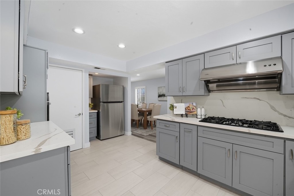 916 Othello Street Arcadia, CA 91006 - Photo 11 of 56 a kitchen with a refrigerator a stove and cabinets