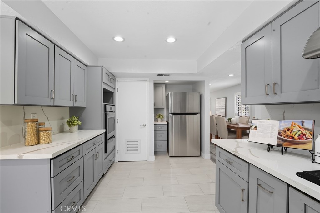 916 Othello Street Arcadia, CA 91006 - Photo 12 of 56 a kitchen with white cabinets and refrigerator