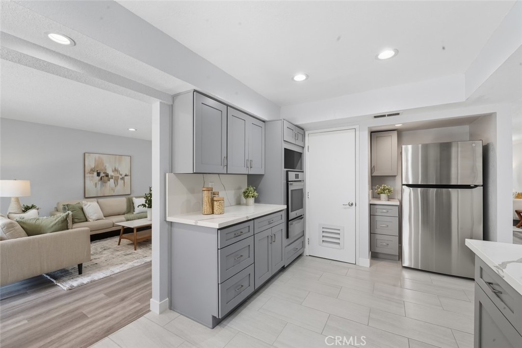 916 Othello Street Arcadia, CA 91006 - Photo 13 of 56 a kitchen with white cabinets and refrigerator