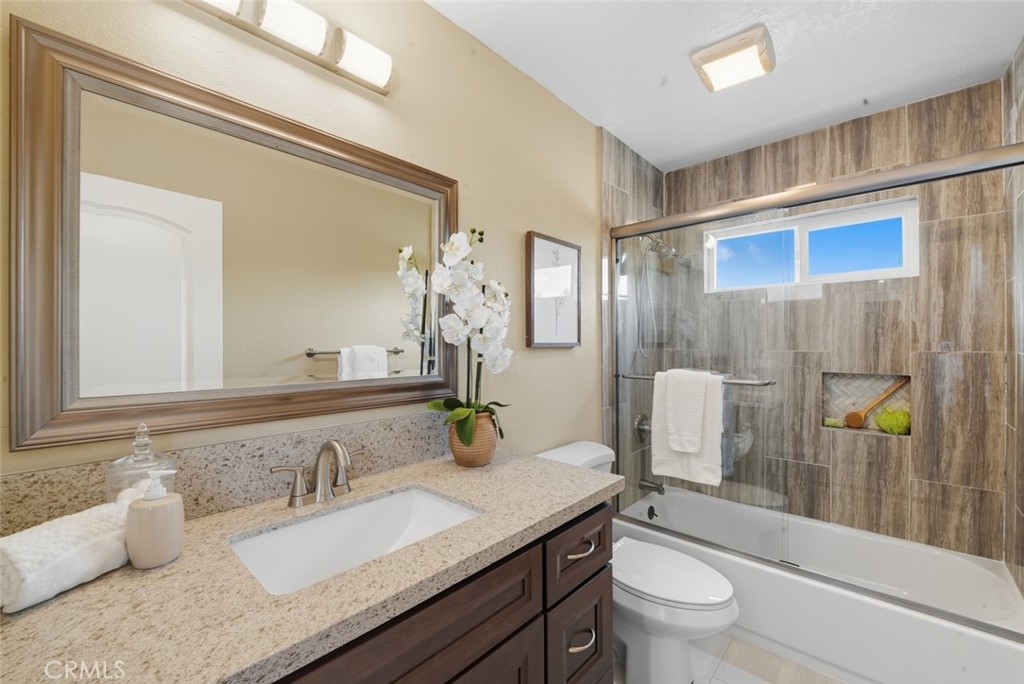 916 Othello Street Arcadia, CA 91006 - Photo 31 of 56 a bathroom with a granite countertop sink a toilet and shower