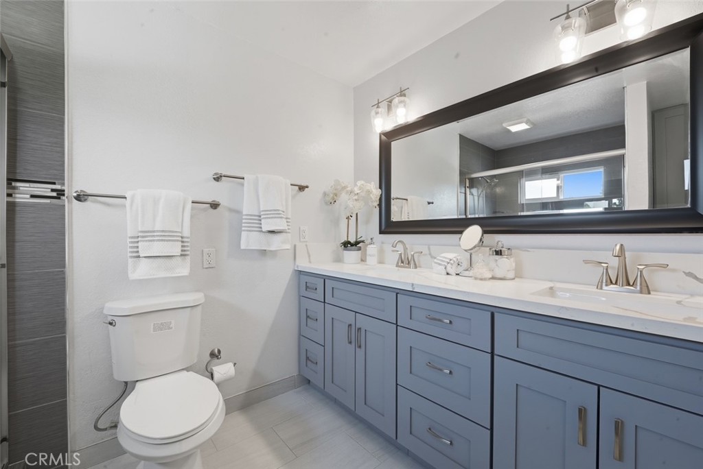 916 Othello Street Arcadia, CA 91006 - Photo 40 of 56 a bathroom with a toilet a double vanity sink and a mirror