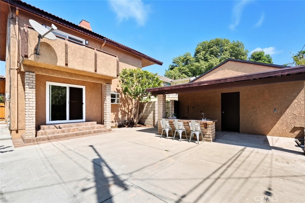 916 Othello Street Arcadia, CA 91006 - Photo 48 of 56 a patio with a table and chairs under an umbrella