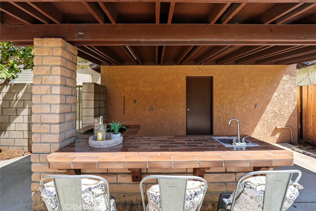 916 Othello Street Arcadia, CA 91006 - Photo 49 of 56 a bathroom with a granite countertop sink and a mirror