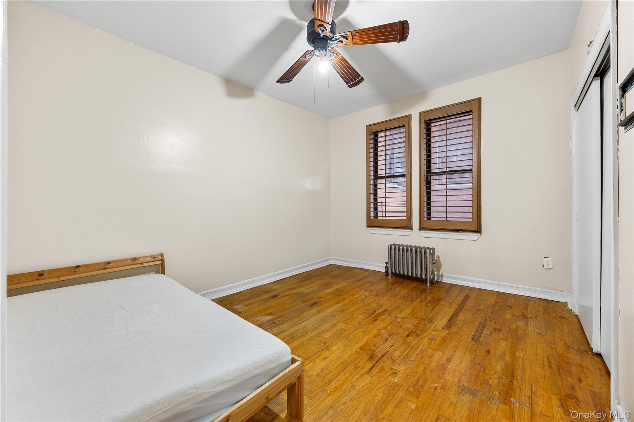 1670 Longfellow Avenue, Unit 3J Bronx, NY 10460 - Photo 12 of 23 a bedroom with a bed and a window