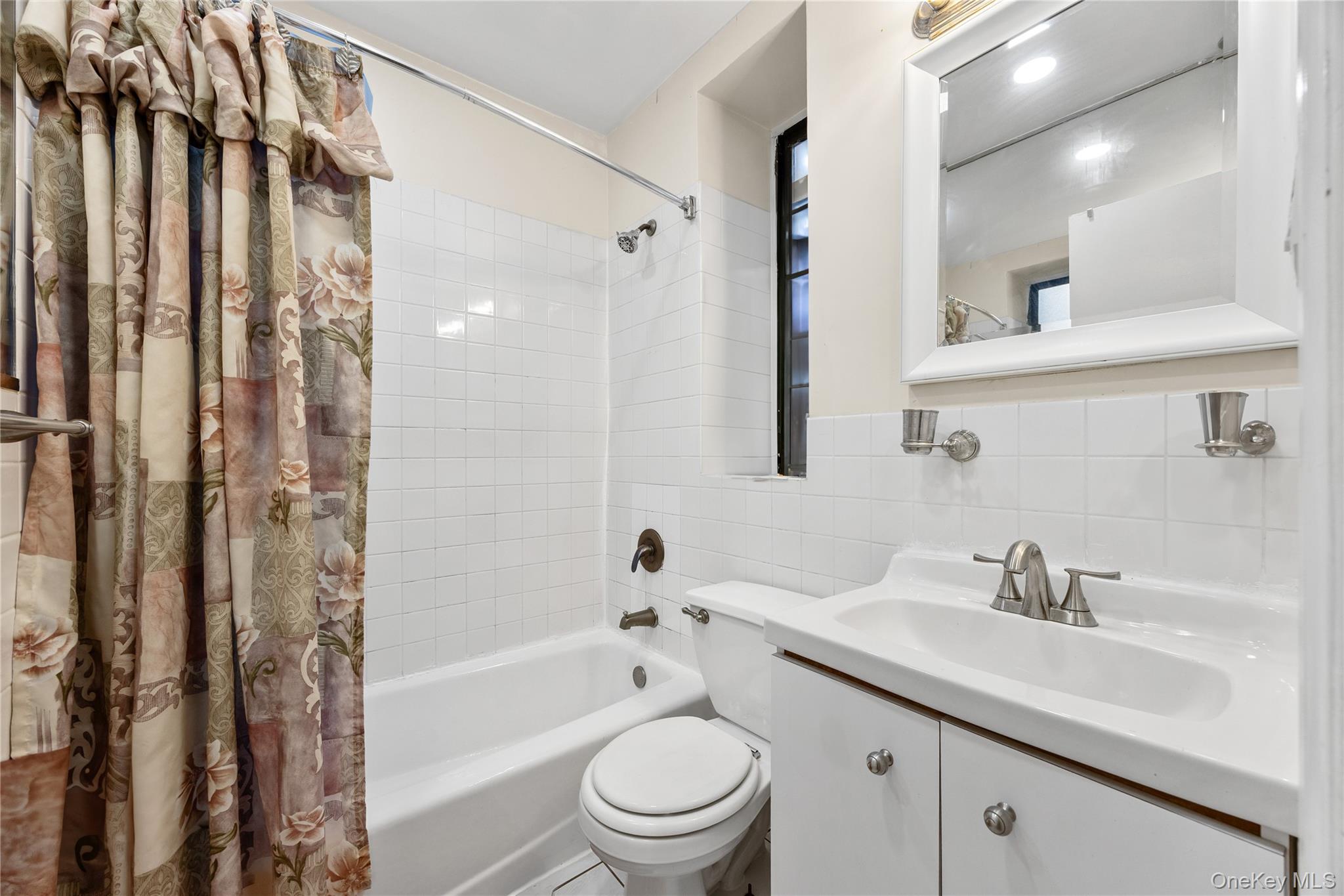 1670 Longfellow Avenue, Unit 3J Bronx, NY 10460 - Photo 15 of 23 a bathroom with a granite countertop sink a toilet a mirror a vanity and shower