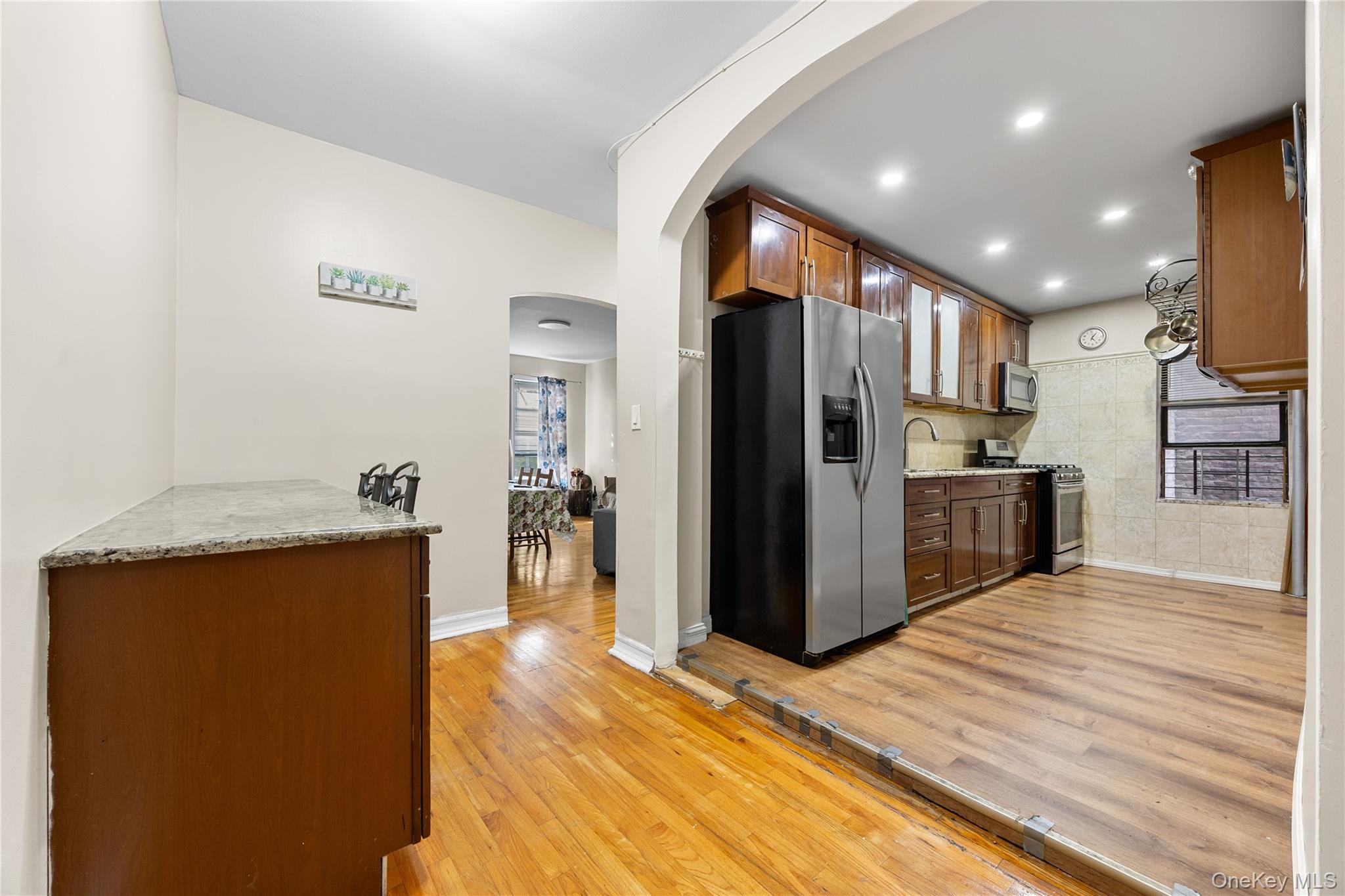 1670 Longfellow Avenue, Unit 3J Bronx, NY 10460 - Photo 4 of 23 a kitchen with stainless steel appliances a refrigerator and a wooden floor