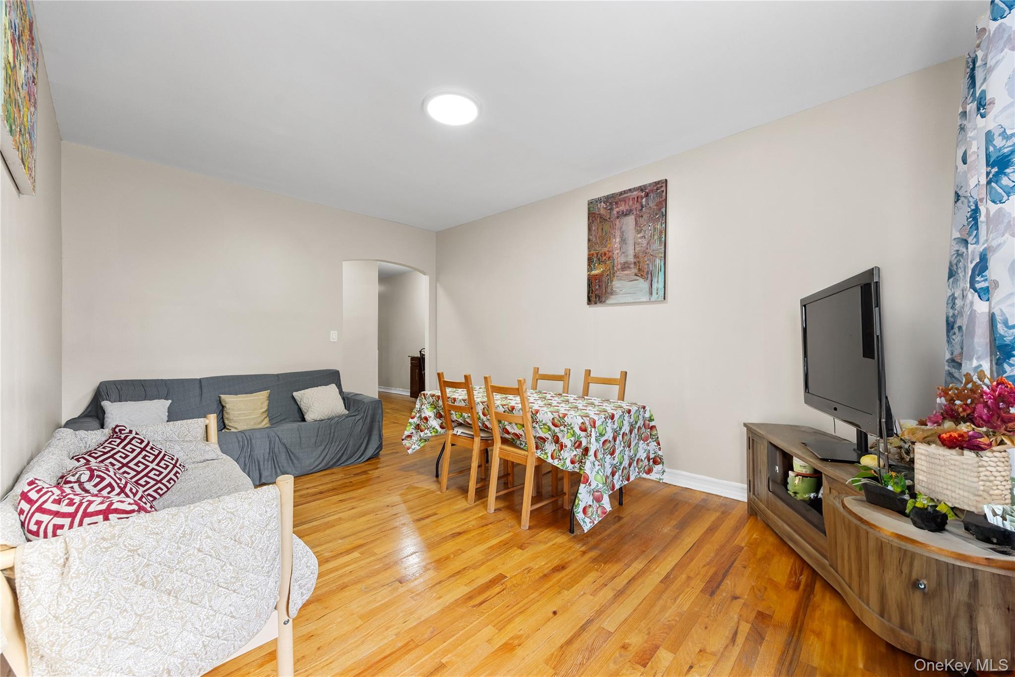 1670 Longfellow Avenue, Unit 3J Bronx, NY 10460 - Photo 9 of 23 a living room with furniture and a flat screen tv