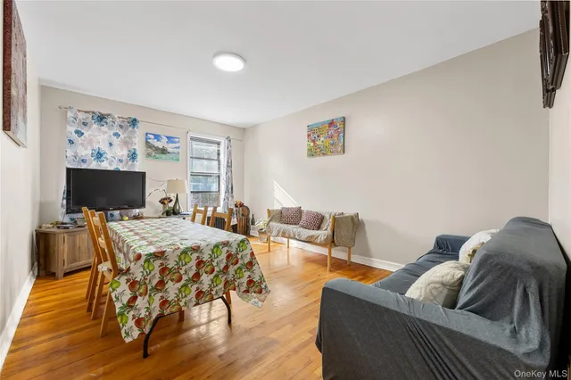 an empty room with a ceiling fan and wooden floor