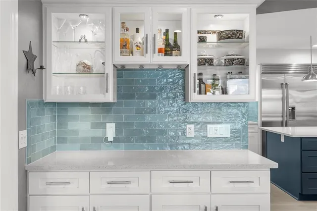 a kitchen with a sink a stove and cabinets
