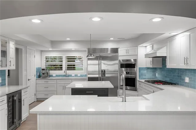 a view of a dining room with furniture wooden floor and a chandelier