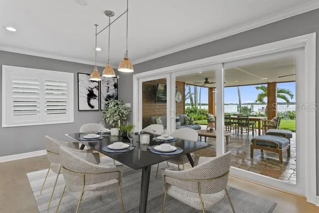 a living room with patio furniture and a flat screen tv
