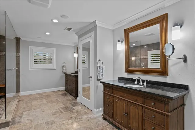 a bedroom with a bed and a dresser next to a window