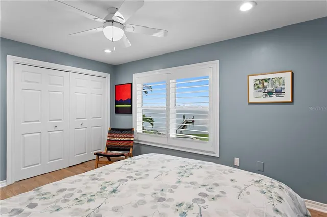 a bedroom with a bed and a book shelf