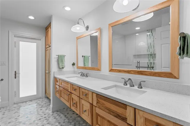 a front view of a house with a yard and potted plants