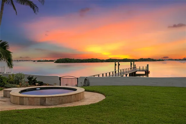 a view of a chairs and table in patio with a lake view