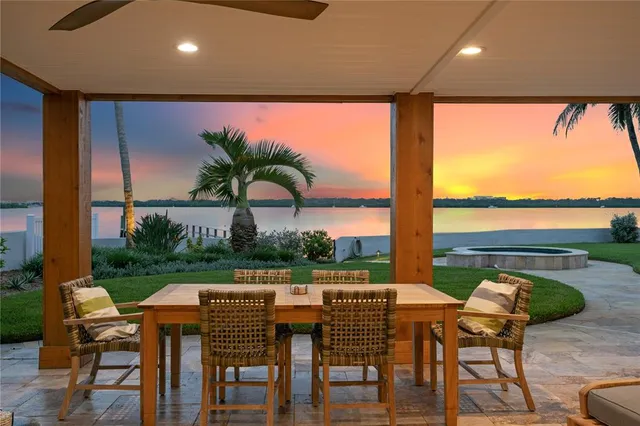 a living room with patio furniture and a flat screen tv