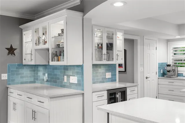 a kitchen with kitchen island a counter top space stainless steel appliances and cabinets