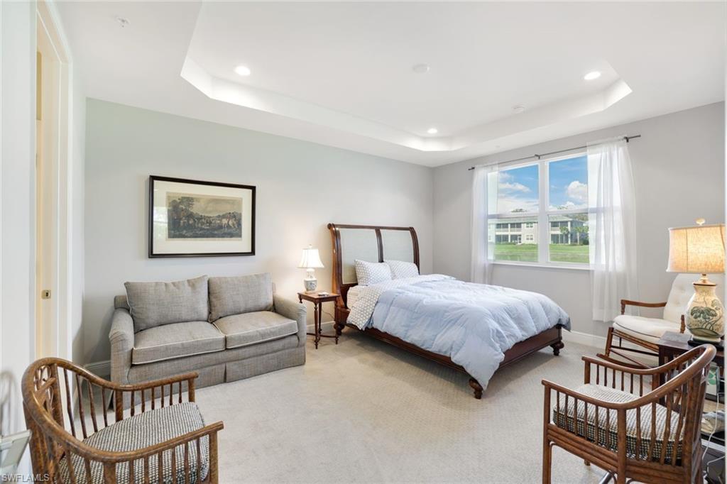 2647 Seychelles Circle, Unit 2204 Naples, FL 34112 - Photo 11 of 29 a bedroom with a bed and a couch