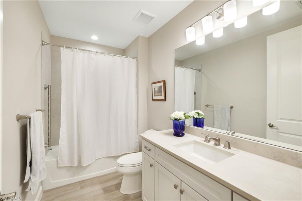 2647 Seychelles Circle, Unit 2204 Naples, FL 34112 - Photo 15 of 29 a bathroom with a sink a toilet and shower