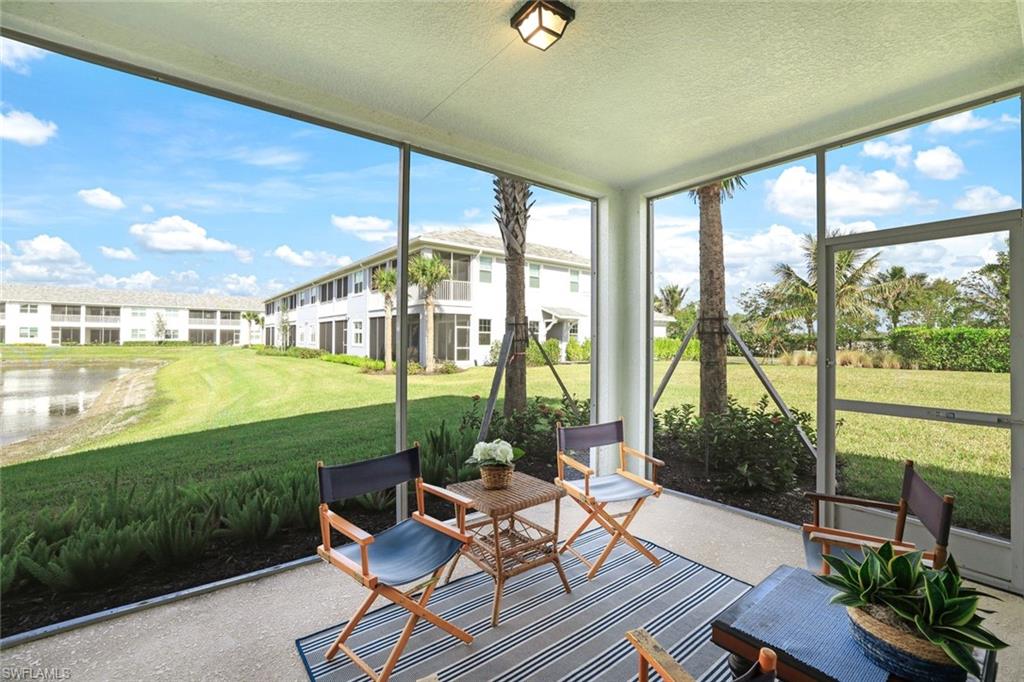 2647 Seychelles Circle, Unit 2204 Naples, FL 34112 - Photo 17 of 29 a living room with furniture and garden view