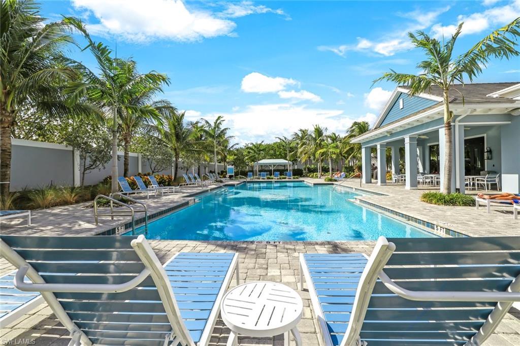 2647 Seychelles Circle, Unit 2204 Naples, FL 34112 - Photo 20 of 29 a view of a patio with swimming pool