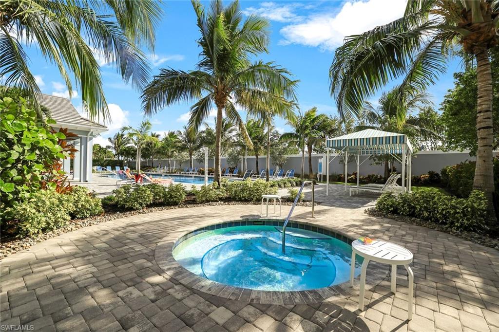 2647 Seychelles Circle, Unit 2204 Naples, FL 34112 - Photo 22 of 29 a swimming pool with outdoor seating yard and palm tree