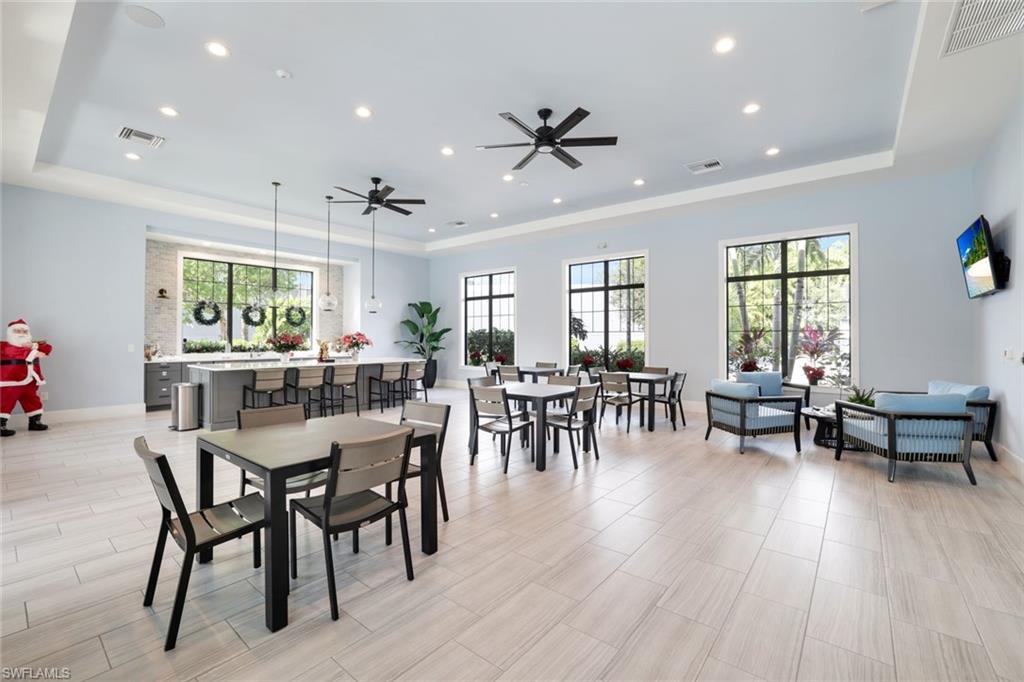 2647 Seychelles Circle, Unit 2204 Naples, FL 34112 - Photo 24 of 29 a view of a dining room with furniture and wooden floor