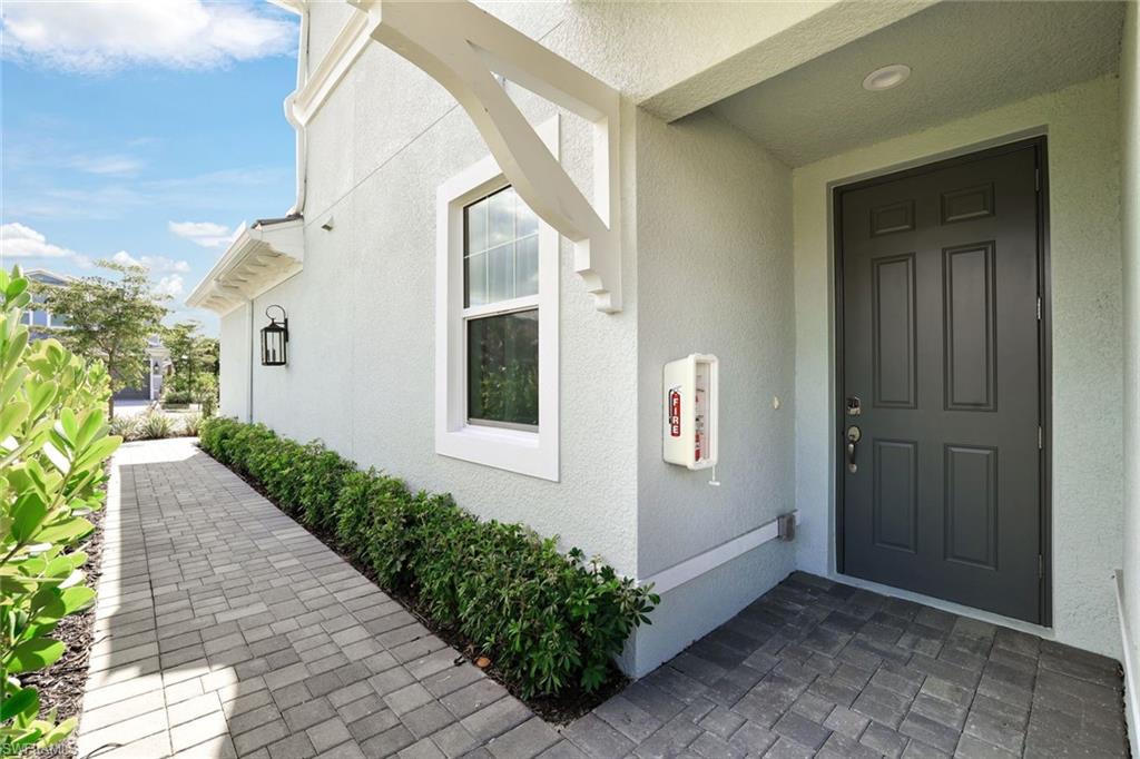2647 Seychelles Circle, Unit 2204 Naples, FL 34112 - Photo 25 of 29 a view of a house with potted plants