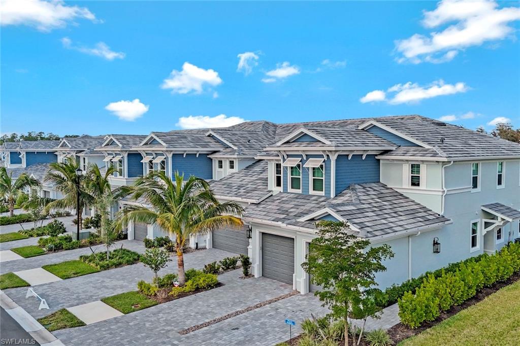 2647 Seychelles Circle, Unit 2204 Naples, FL 34112 - Photo 26 of 29 a front view of a house with a yard