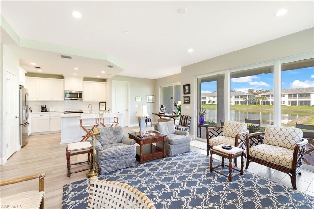 2647 Seychelles Circle, Unit 2204 Naples, FL 34112 - Photo 6 of 29 a living room with furniture and a rug