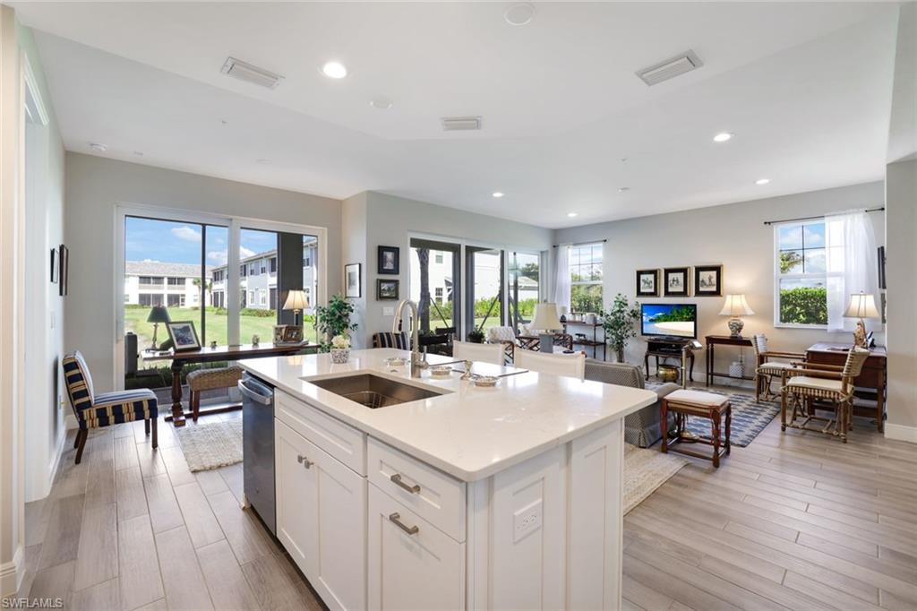 2647 Seychelles Circle, Unit 2204 Naples, FL 34112 - Photo 8 of 29 a view of living room kitchen with stainless steel appliances granite countertop and couch