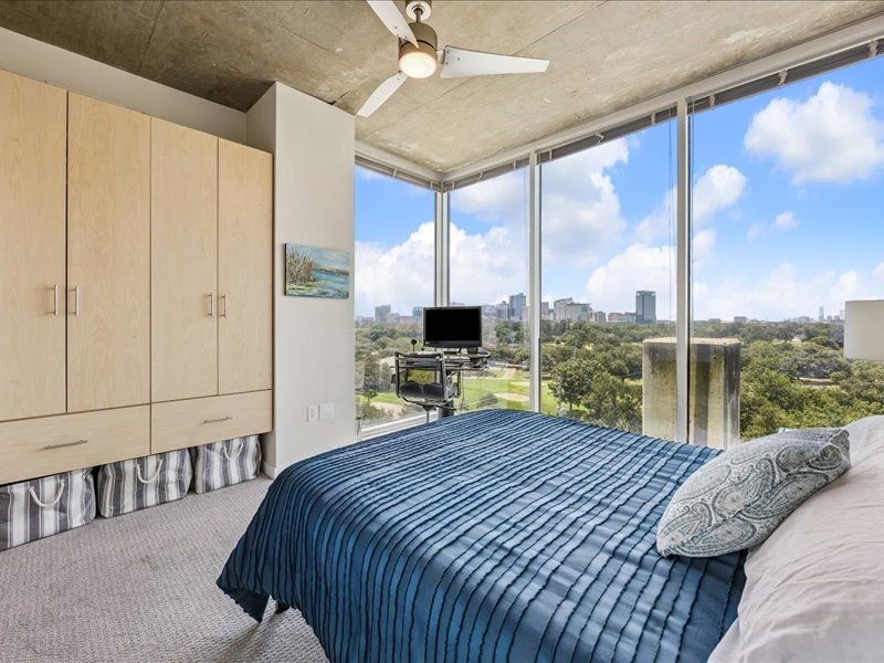 5925 Almeda Road, Unit 10714 Houston, TX 77004 - Photo 7 of 38 a bedroom with a large bed and a tv