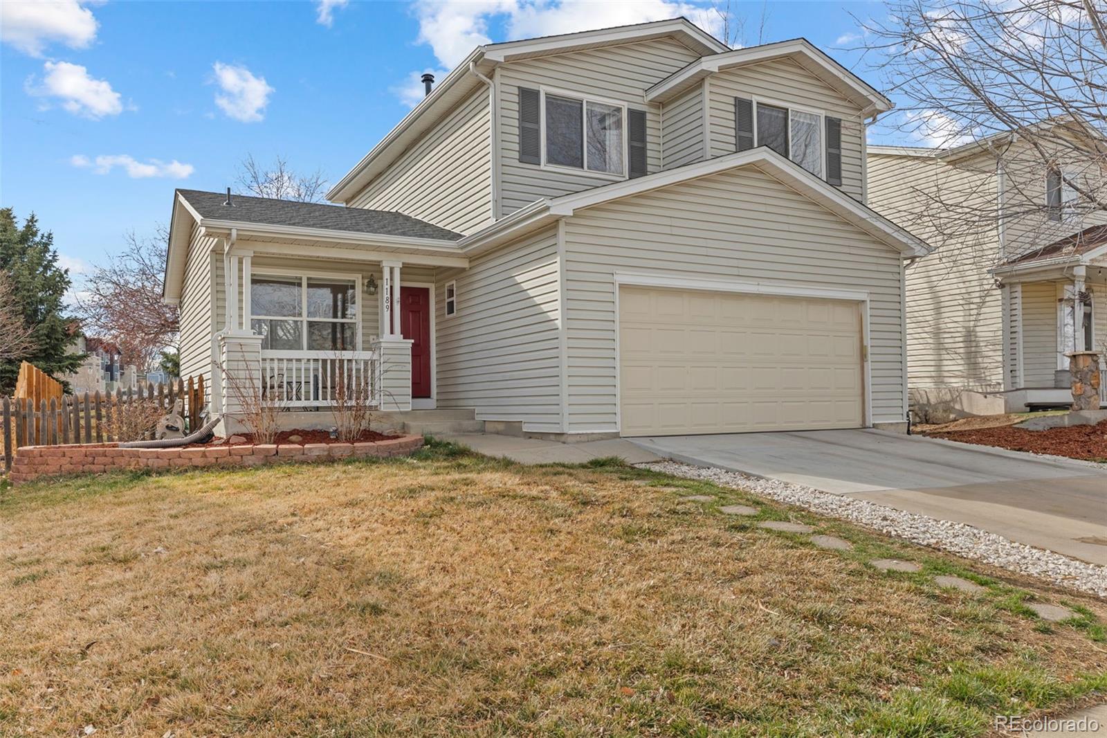 1189 Fall River Circle Longmont, CO 80504 - Photo 1 of 46 a front view of a house with a yard and garage