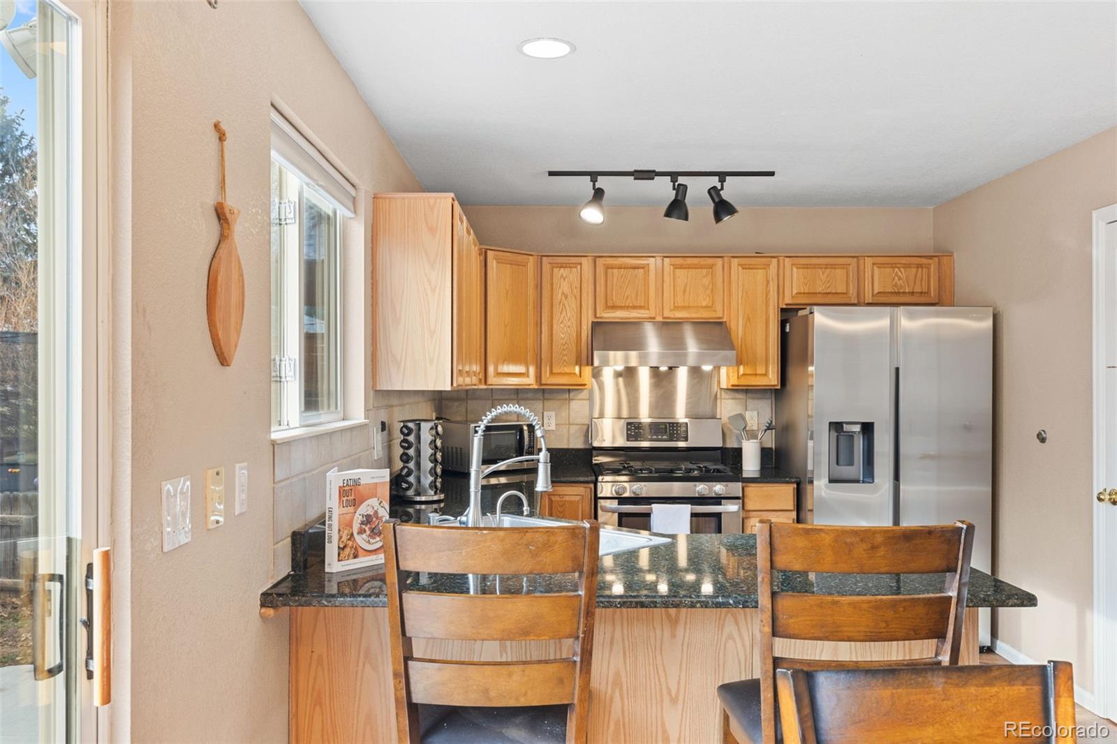 1189 Fall River Circle Longmont, CO 80504 - Photo 12 of 46 a kitchen with stainless steel appliances granite countertop a refrigerator and a stove top oven