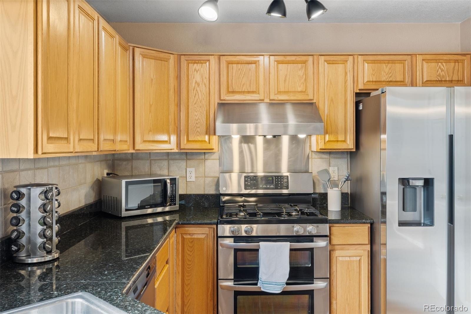 1189 Fall River Circle Longmont, CO 80504 - Photo 15 of 46 a kitchen with stainless steel appliances granite countertop a stove a sink and a refrigerator